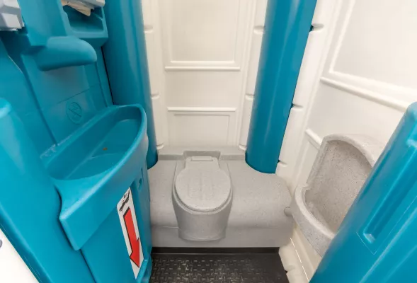 Interno di un bagno chimico portatile con wc lavabo e orinatoio